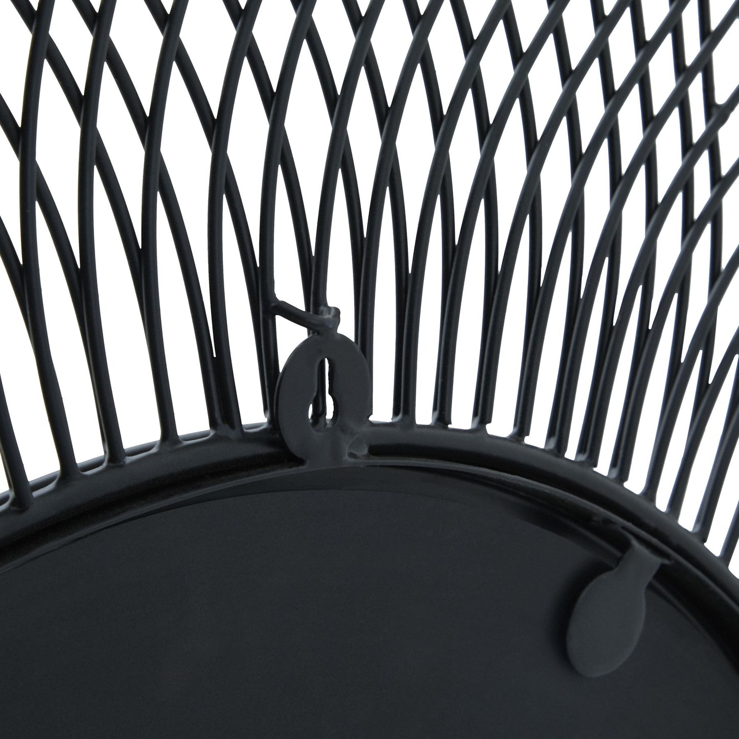 Close-up of a black metal chair with intricate woven design on a white background