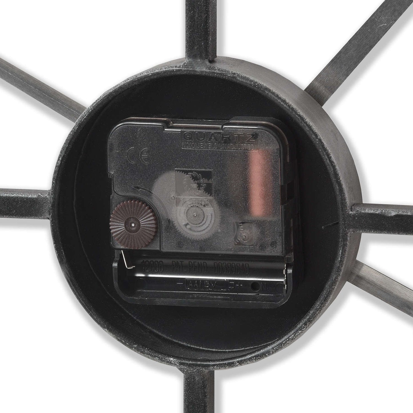 Close-up of a mechanical component inside a black metal wheel on a white background