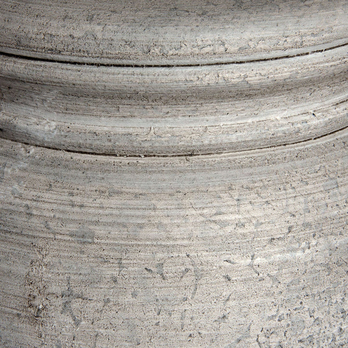 Close-up of a textured gray surface with concentric circular patterns