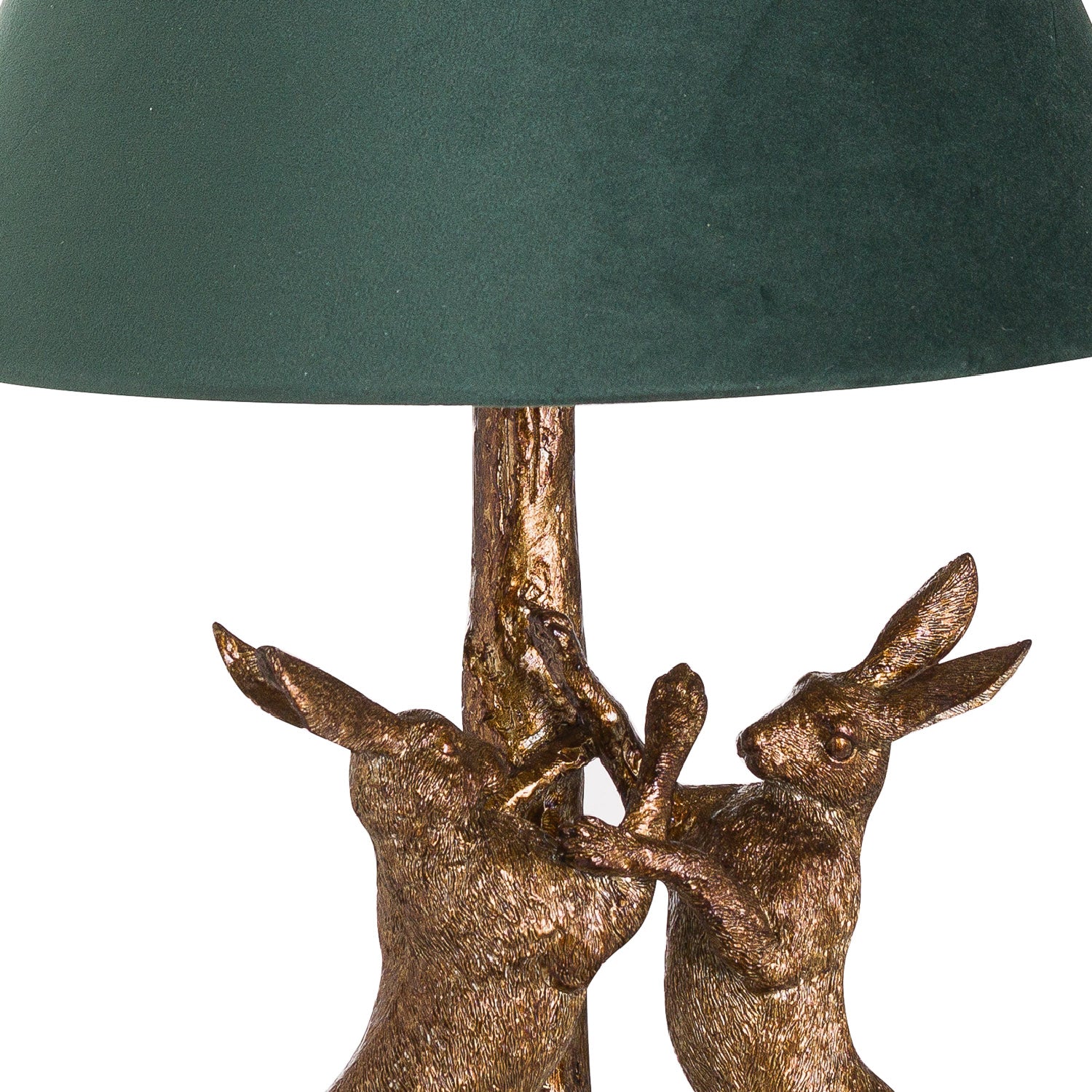 Decorative lamp with bronze rabbit figures and a green lampshade on a white background