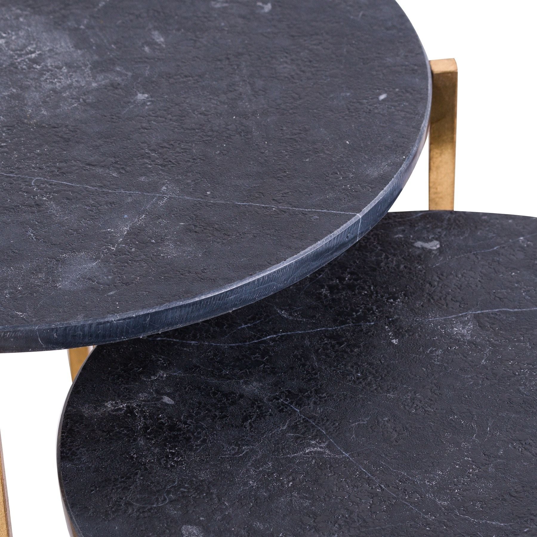 Two round dark marble tables with gold legs on a white background