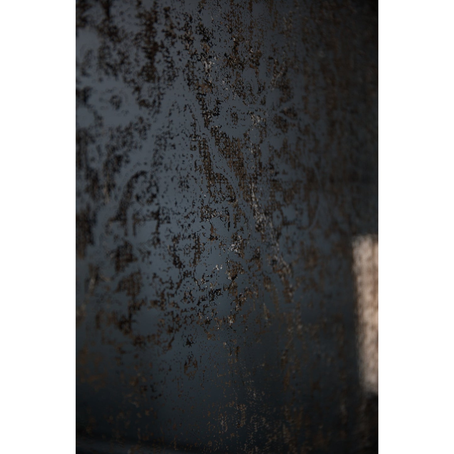 Close-up of a textured metal surface with rust and wear.