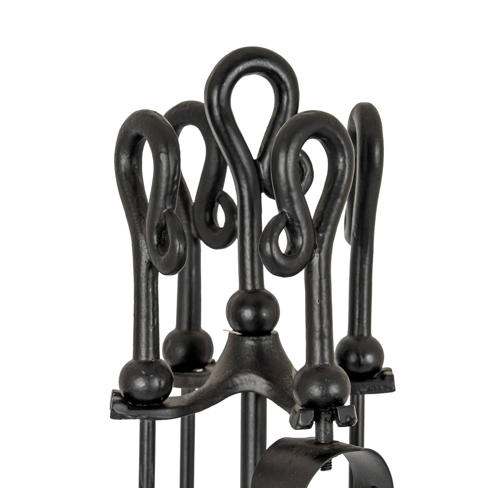 Set of black wrought iron fireplace tools on a white background