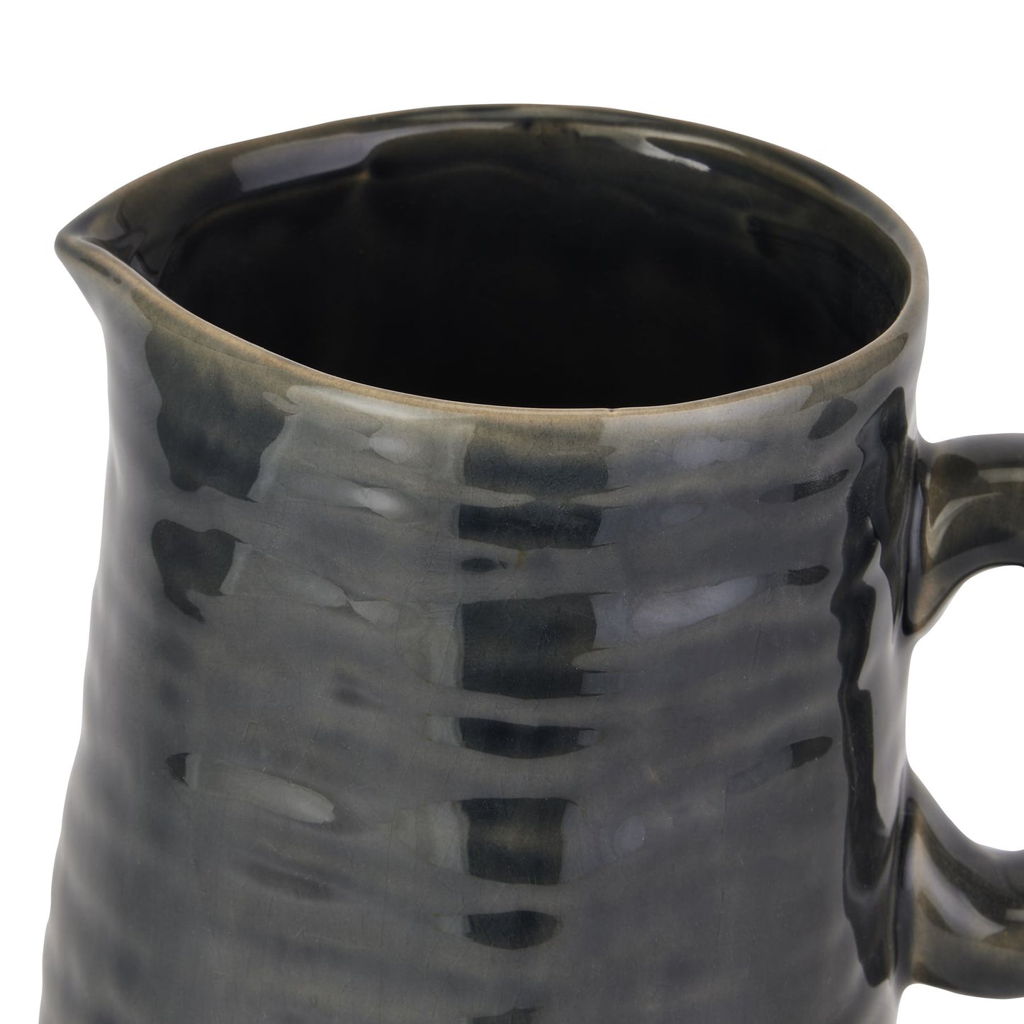 Navy blue ceramic pitcher with textured surface on a white background