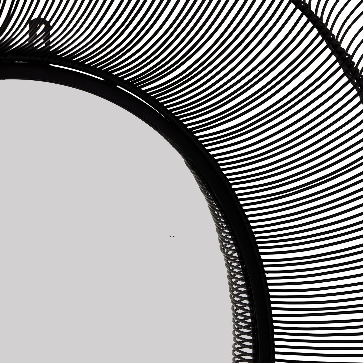 Close-up of a black woven mirror with a white background