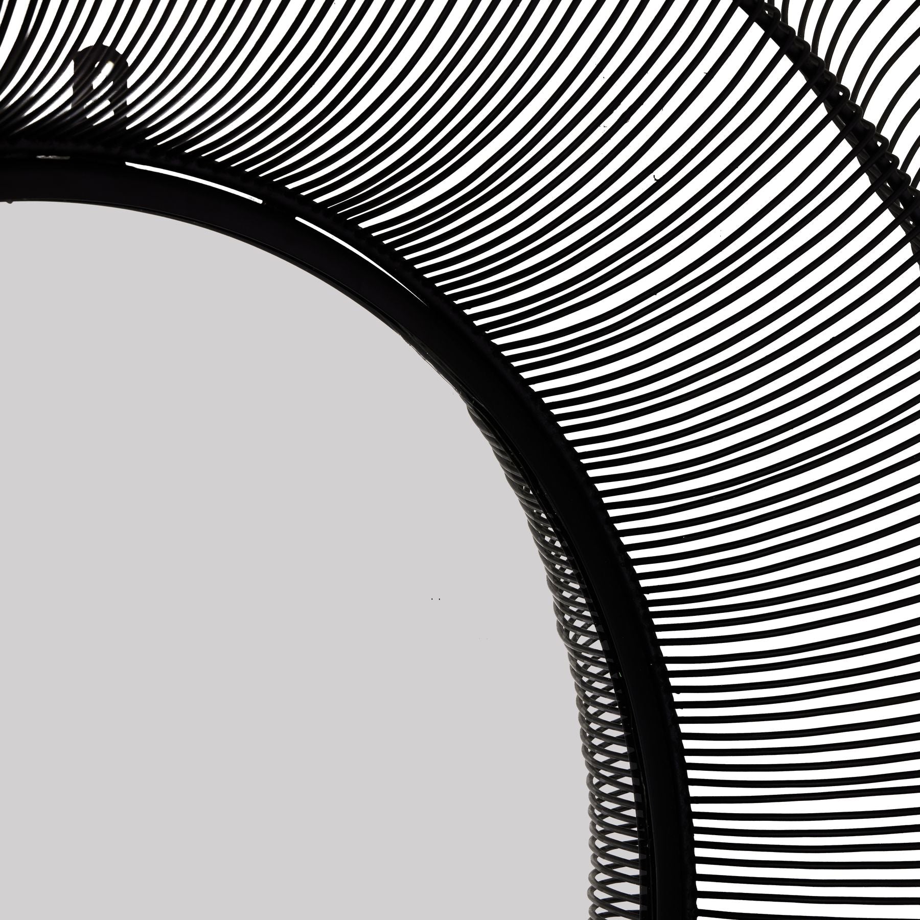 Close-up of a black woven mirror with a white background