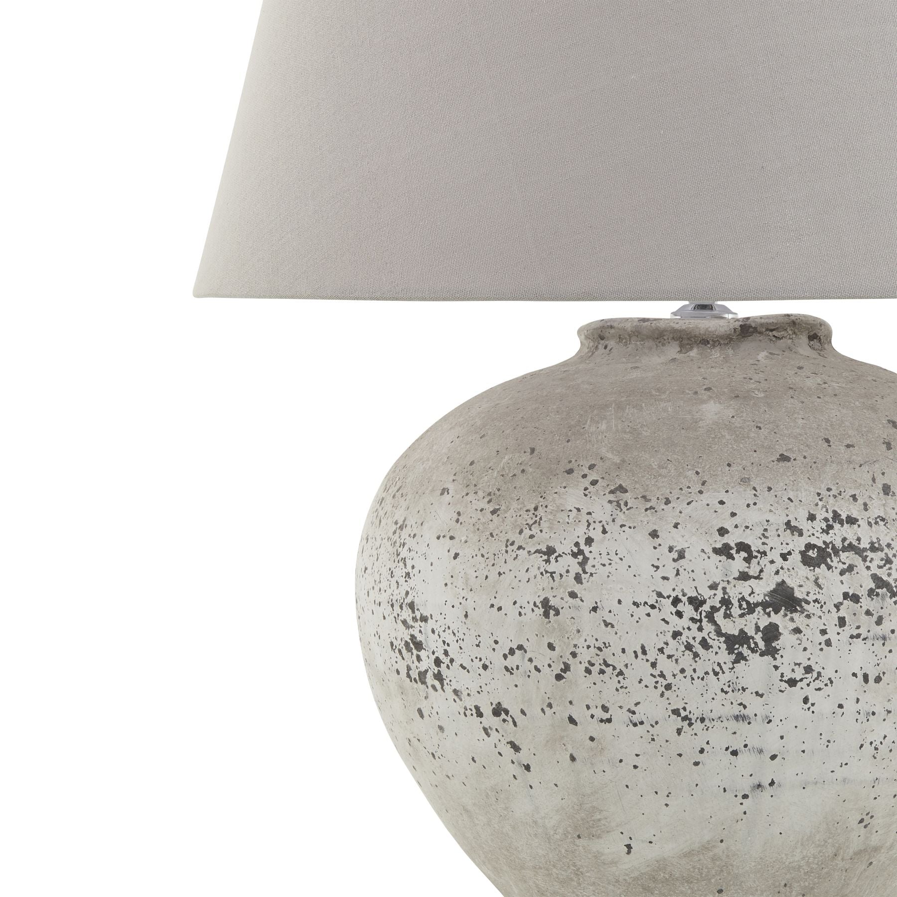 Table lamp with textured gray base and white lampshade on a white background