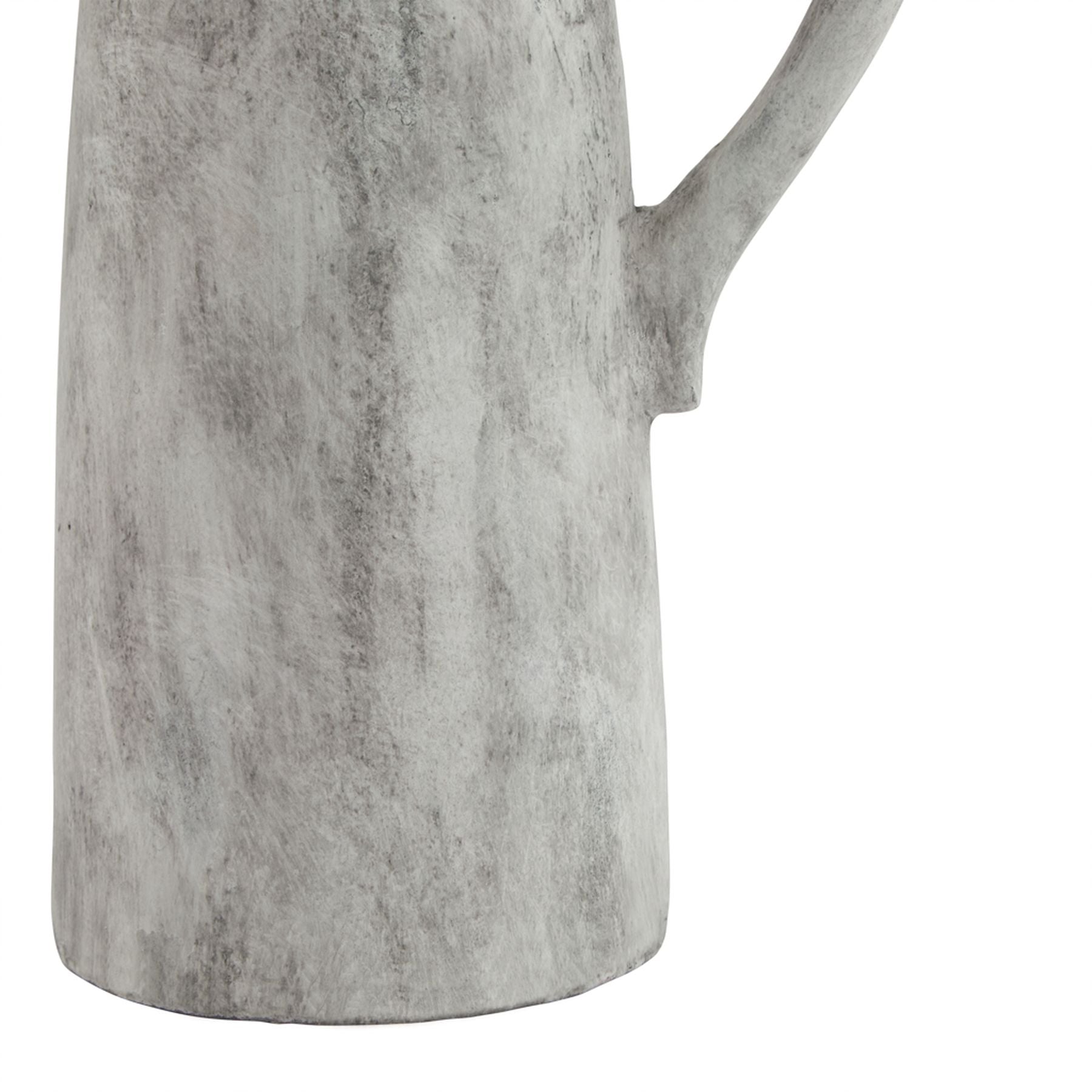 Close-up of a gray ceramic pitcher with a handle on a white background
