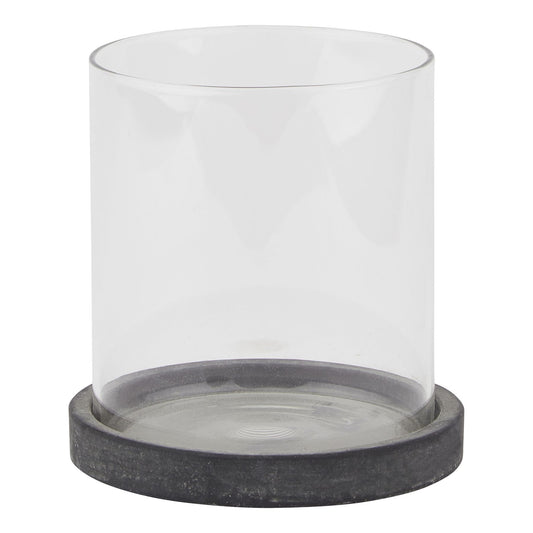 Clear glass candle holder with a dark gray base on a white background