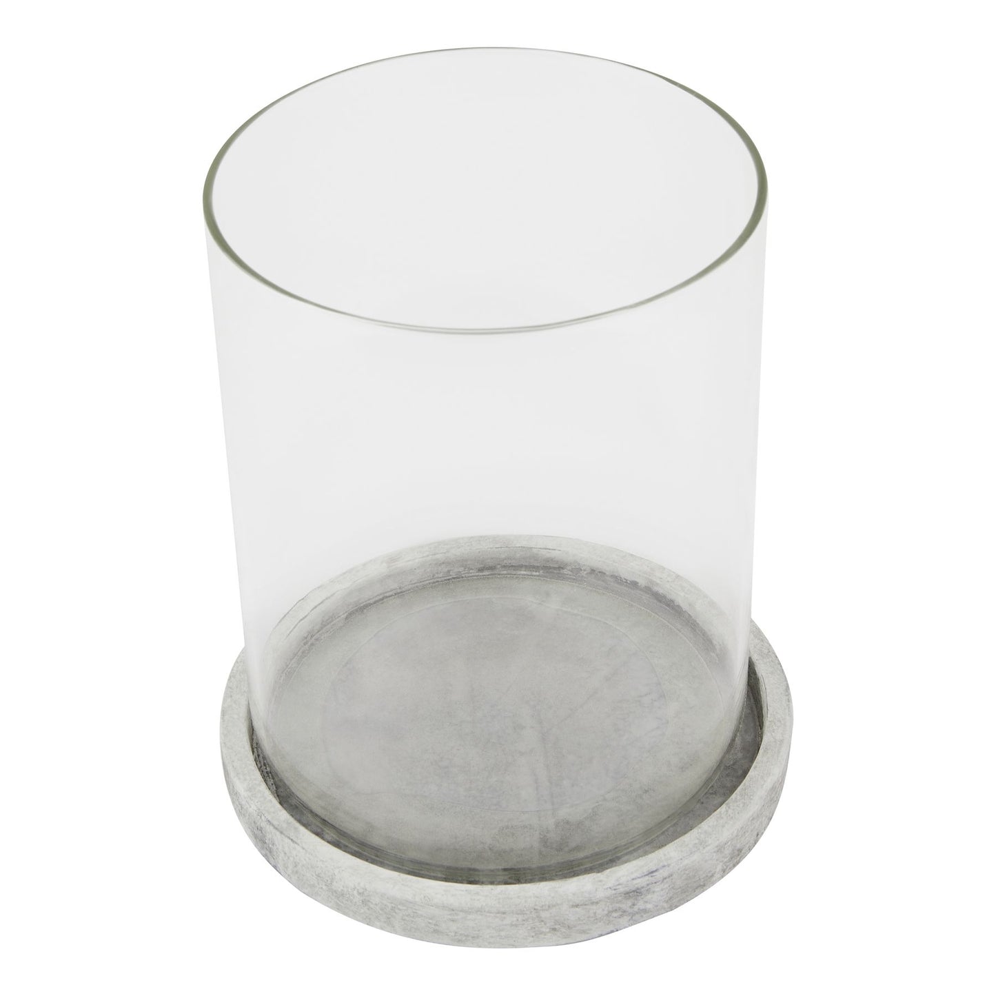 Clear glass candle holder with a concrete base on a white background