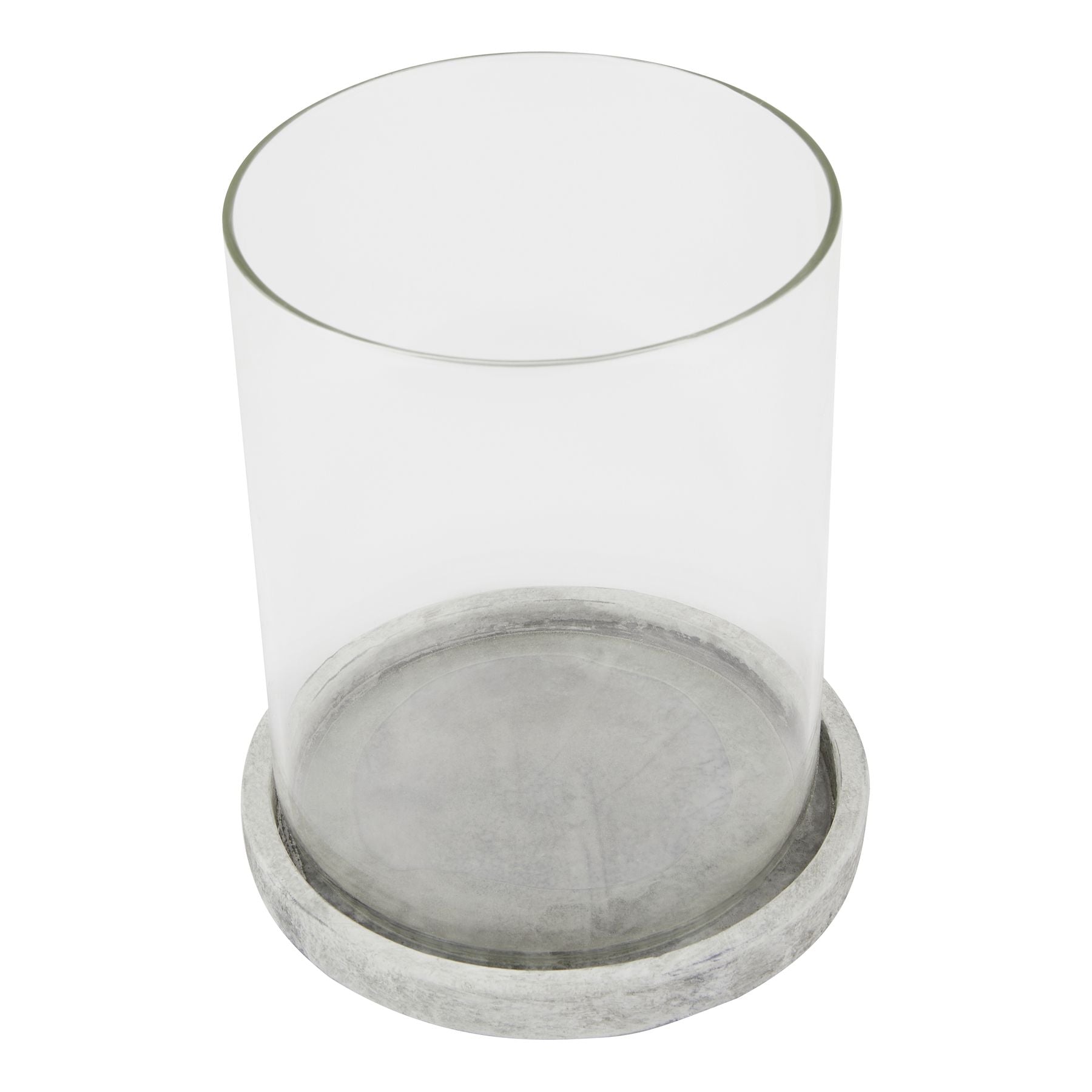 Clear glass candle holder with a concrete base on a white background