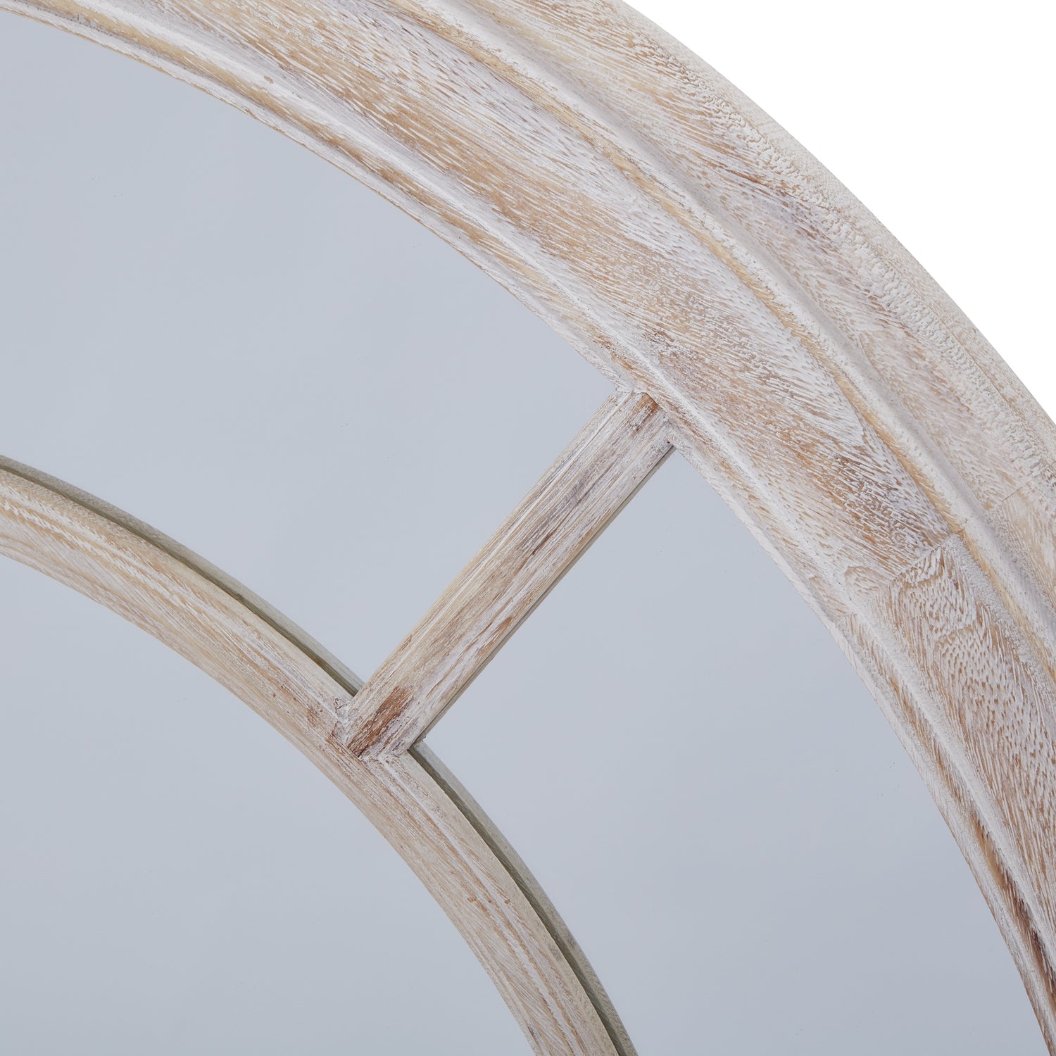 Round mirror with a wooden frame on a light gray background