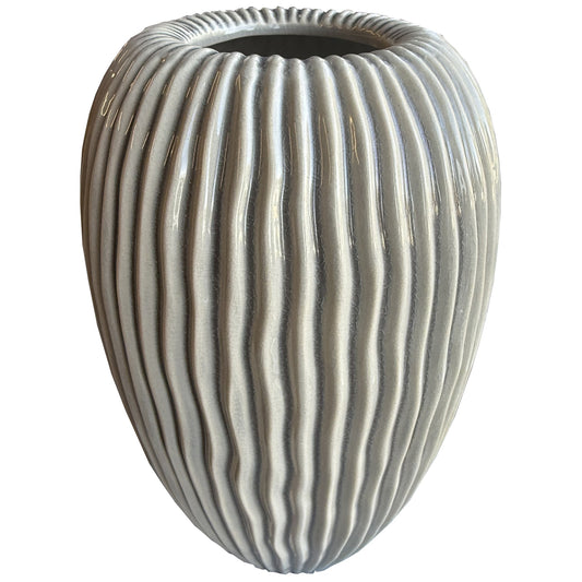 Decorative vase with ribbed texture on a white background