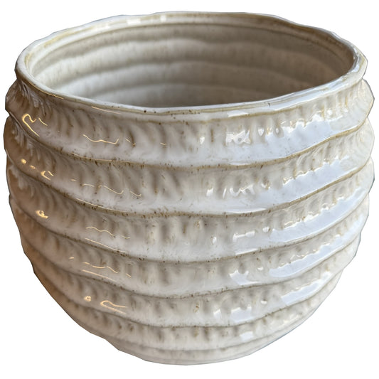 Beige ceramic planter with textured surface on a white background