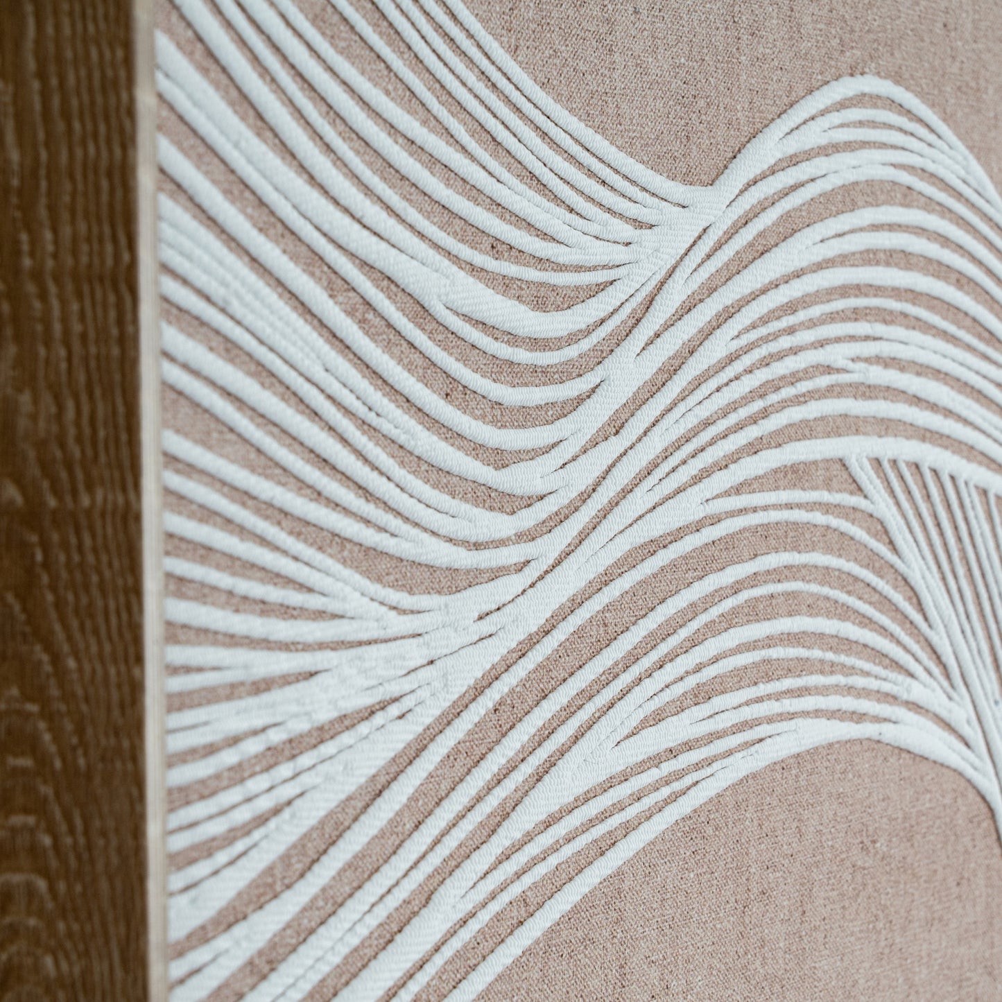 Close-up of a textured surface with wavy white lines on a beige background