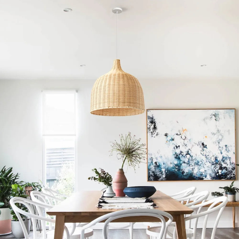 Modern dining room with wooden table, white chairs, and abstract artwork on the wall.
