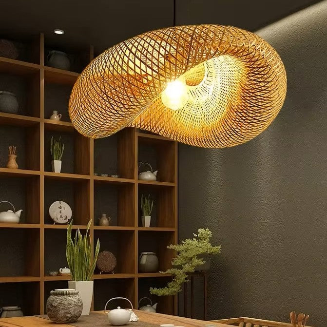 Woven pendant light hanging in a room with wooden shelves and decorative items.