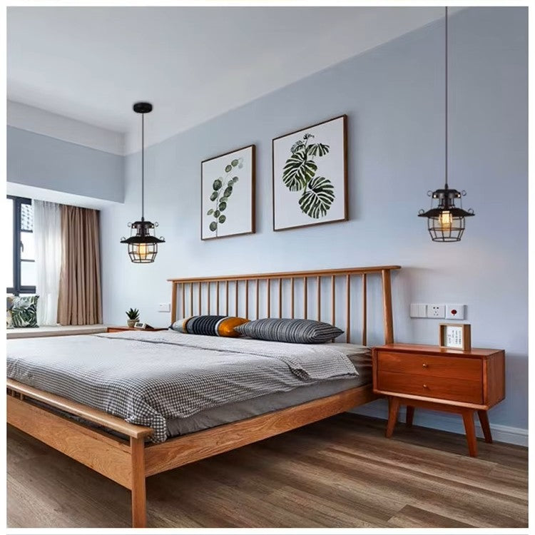 Modern bedroom with wooden bed and nightstands, light blue walls, and decorative lamps.