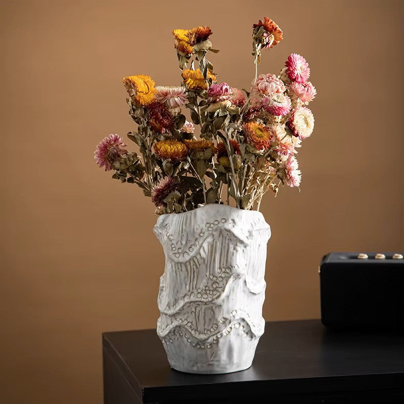 Decorative vase with dried flowers on a brown background